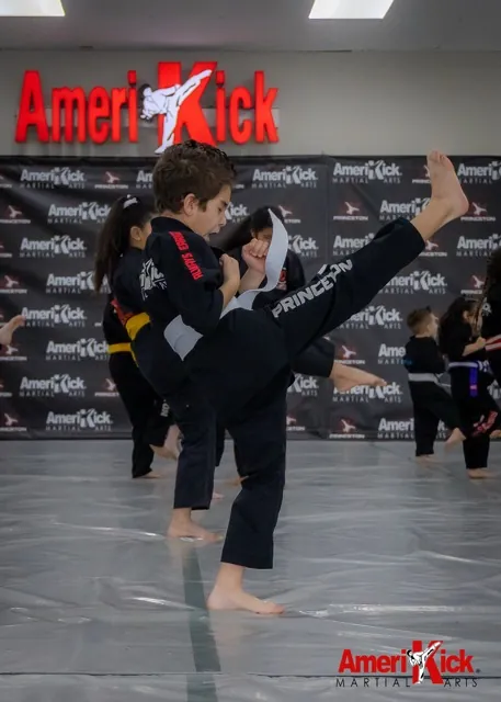 Student executing axe kick at Amerikick Princeton